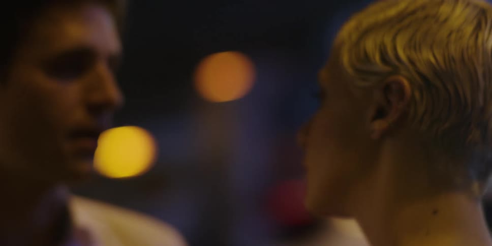 A man and a woman argue while standing outdoors