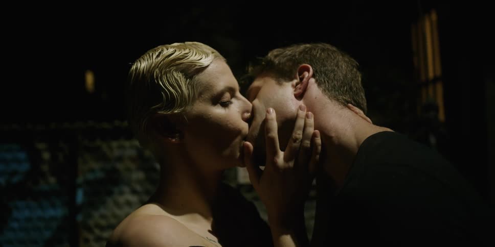 A man and a woman standing and kissing