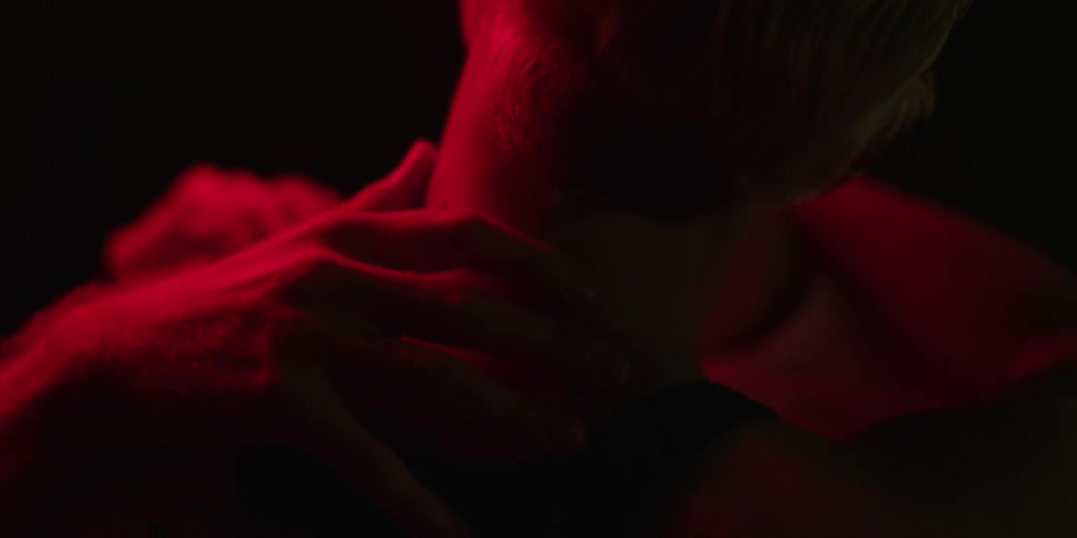 A man and woman embrace and kiss