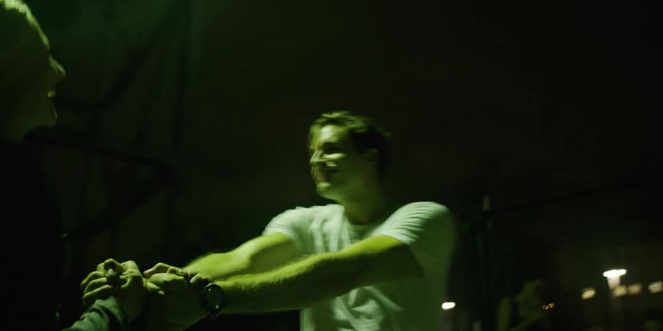 A man and woman are dancing outdoors at night
