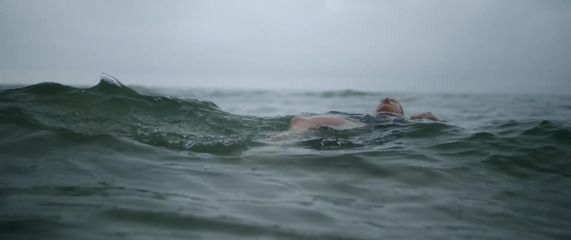 A woman floats in the ocean