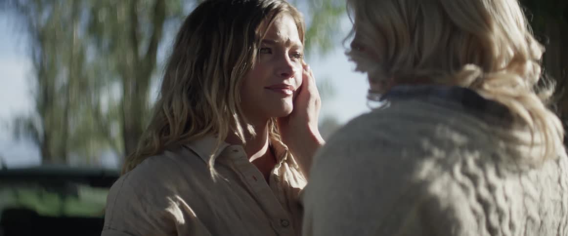 A mother and daughter hug and cry as the daughter leaves