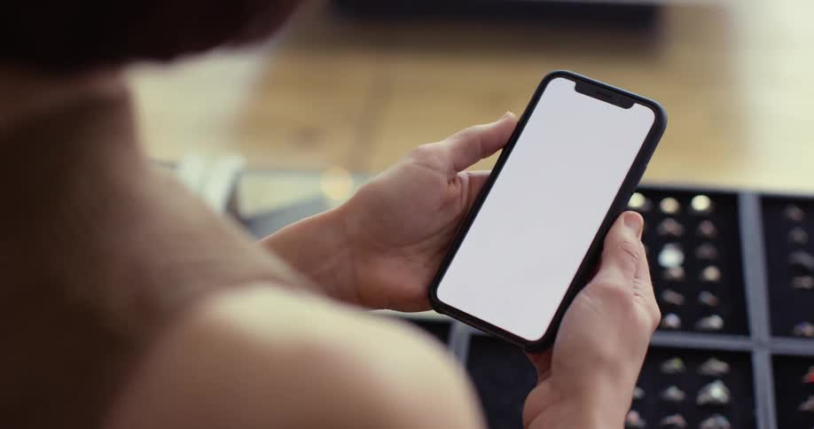 The person lifts the phone to look at it