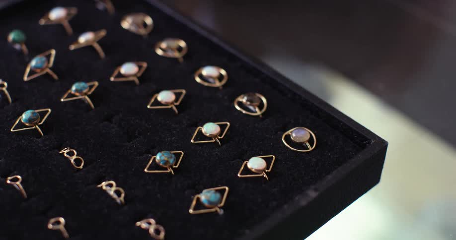A woman looks at rings in a jewelry store