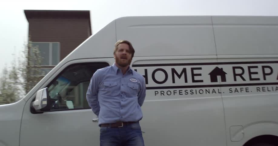 Repairman gets out of van parked on neighborhood street