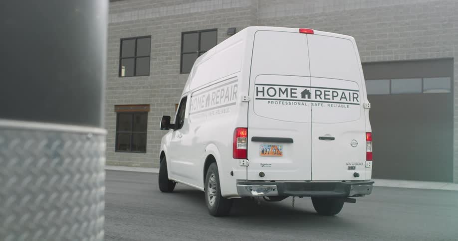 A company owned van backs up and drives away