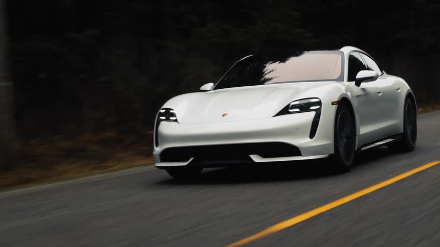 White sports car driving on road in the mountains
