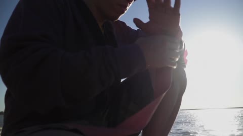 A man wraps his arm in a bandage