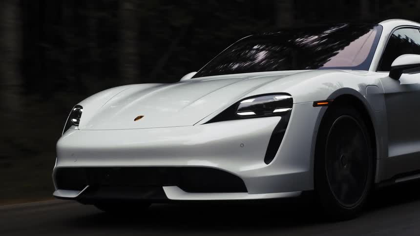 Close up of a white lamborghini driving on a road