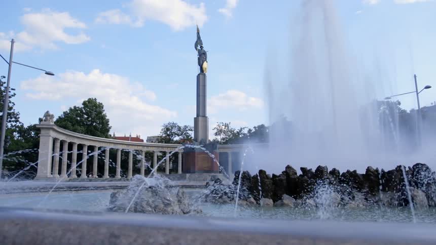 Water shoots out of a fountain at a monument