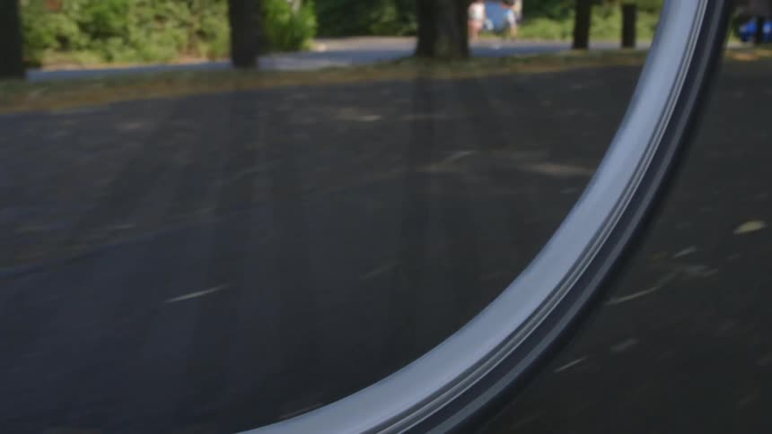 A bicyclist rides in a public park