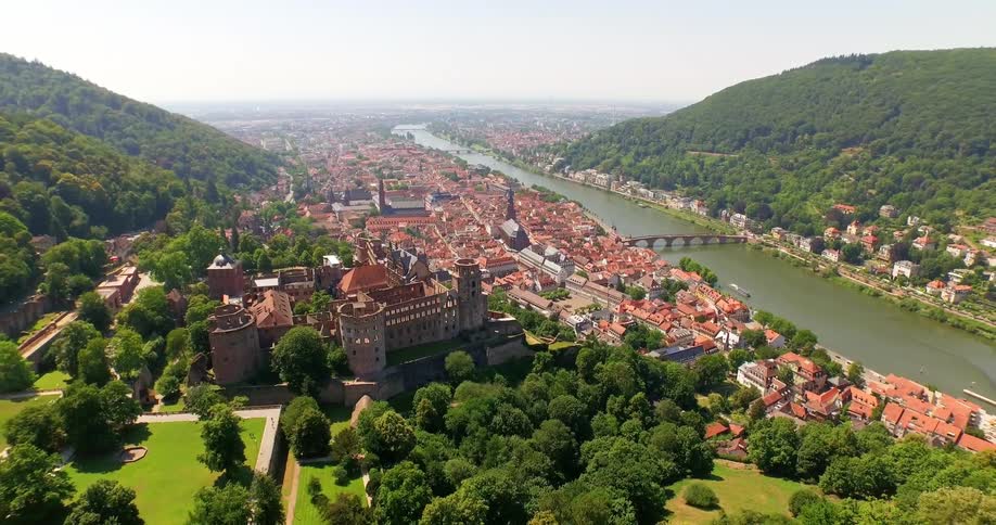 A town sprawls along a river in a mountain valley