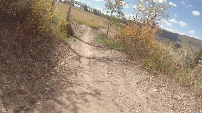 The shadow of a person riding their bike