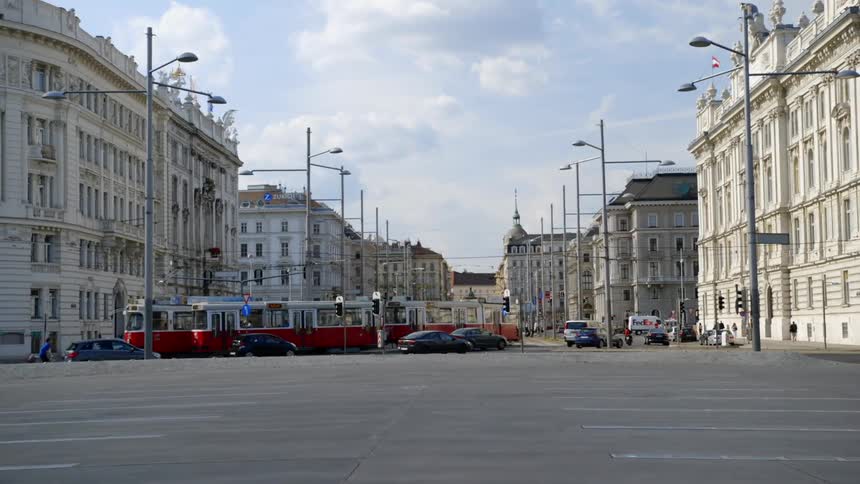 Trains and vehicles move along a city road