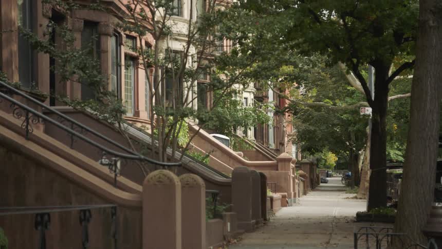 Tree lined street of historic brownstone buildings in a greenwich village neighborhood in manhattan new york city nyc