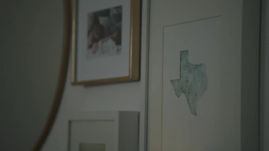 Framed photos and art on wall in home