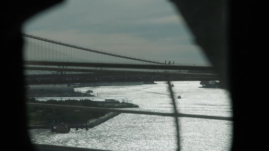 View from window of rail car of river and bridges