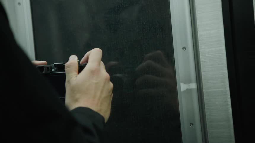 Man taking photos out the window of a moving subway train