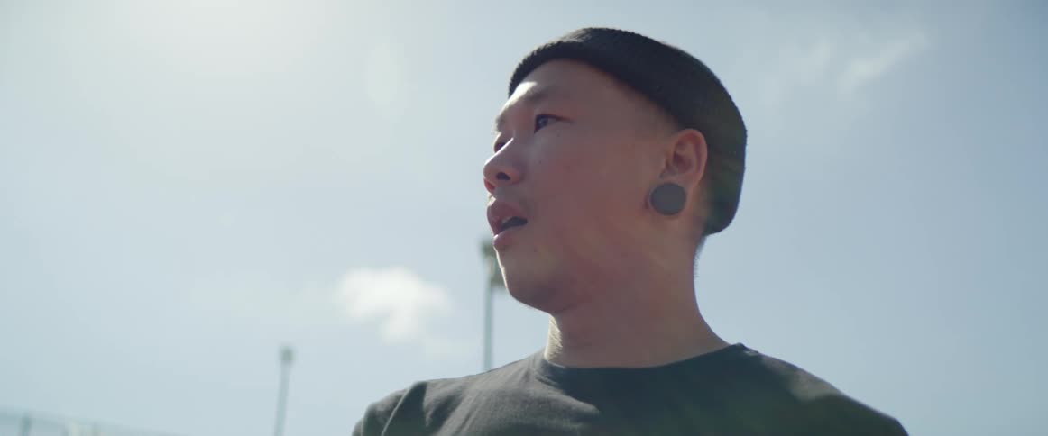 A teenager stands outside and thinks and breathes deeply