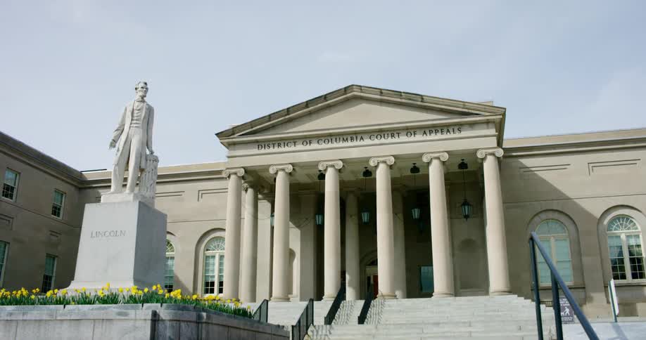 A statue of abraham lincoln is in front of the building