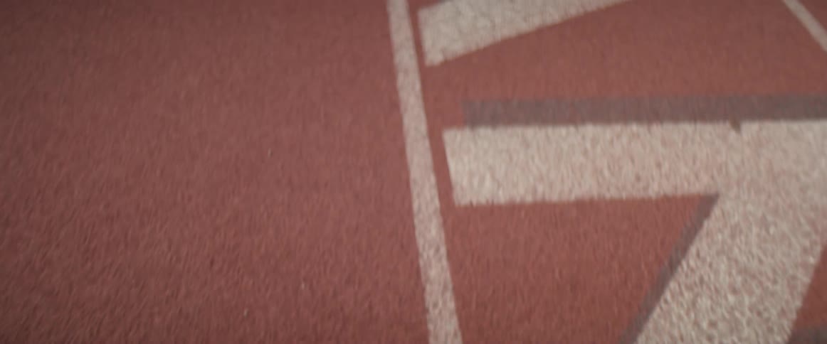 Lines and text are painted on a track field
