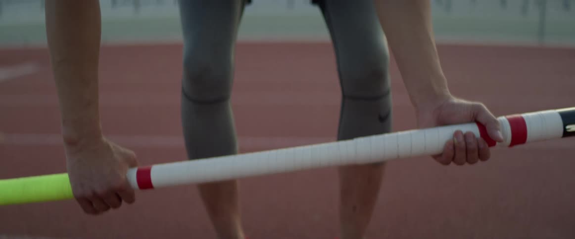 A man is exercising outdoors on a track