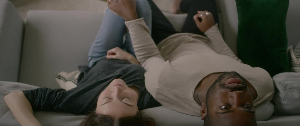 A woman and man are sitting on a couch