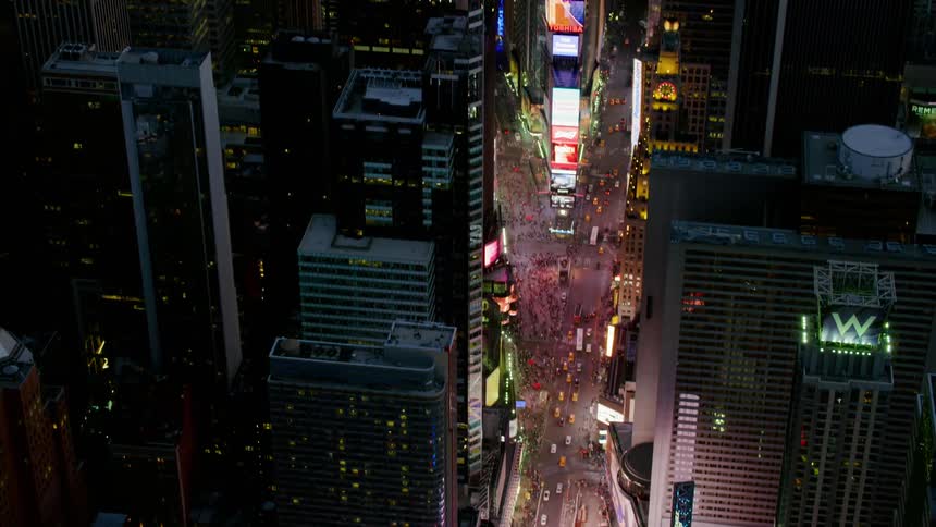 A crowd of people fill a downtown area