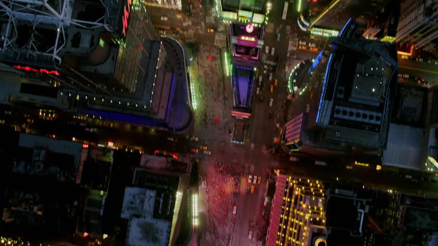 A birds eye view of a downtown city at night is displayed