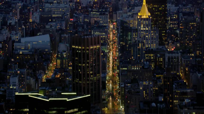 Downtown manhattan and skyline in front of new york harbor at night