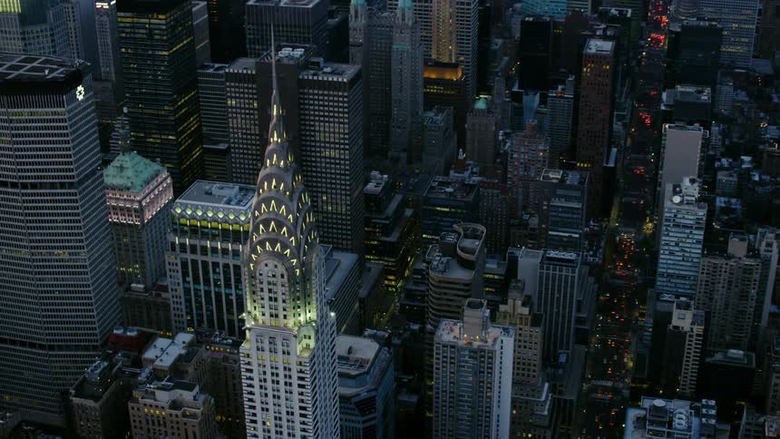 A tall skyscraper looms over a downtown area