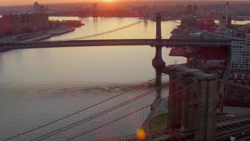 An aerial view of the brooklyn bridge at sunset