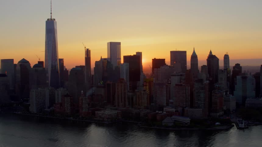 An aerial view of a downtwon city is displayed at dusk
