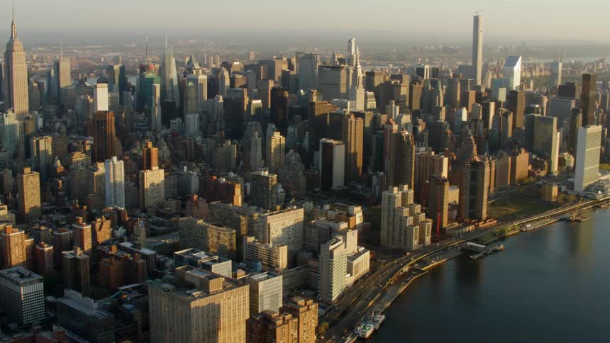 Traffic moves in the city as buildings and skyscrapers stand nearby