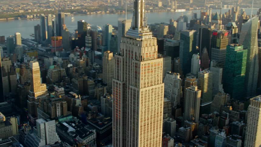The empire state building sits in the middle of the city