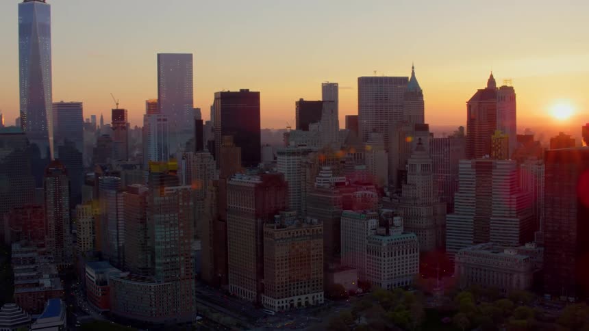 A downtown city is displayed at sunset