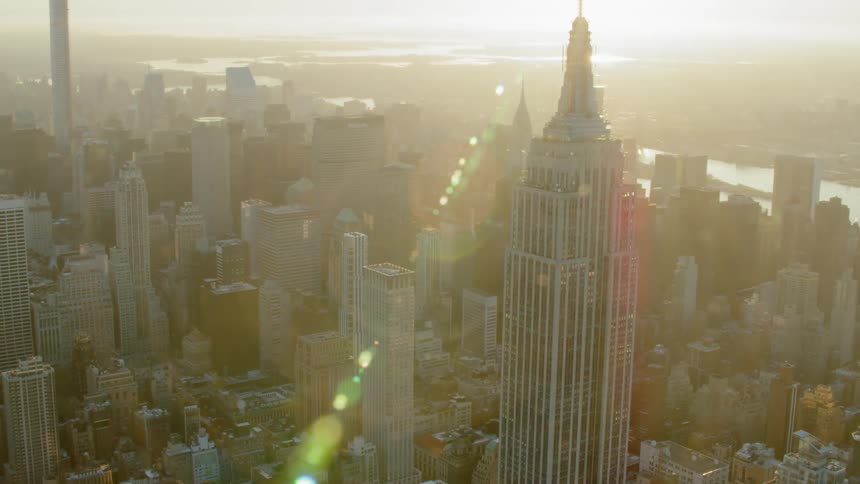 A skyscraper with buildings and the sky in the background