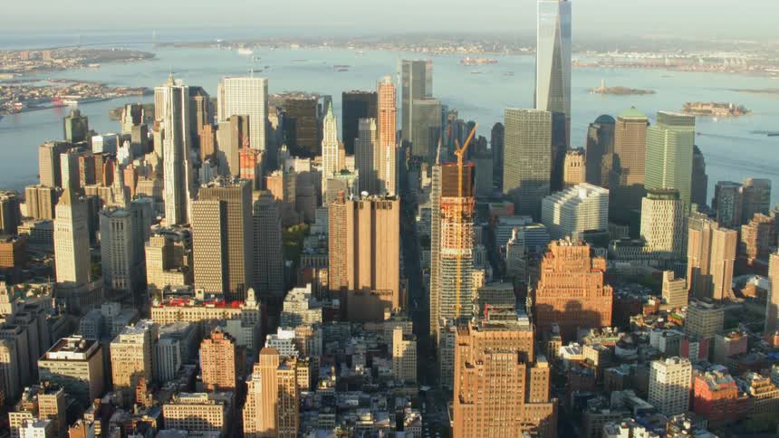 New york city skyline in front of new york harbor at sunset