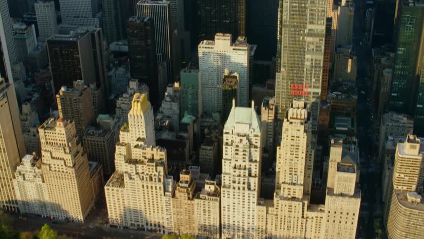 Large park borders downtown tower blocks next to water