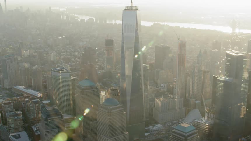 A skyscraper looms high above other buildings in a city