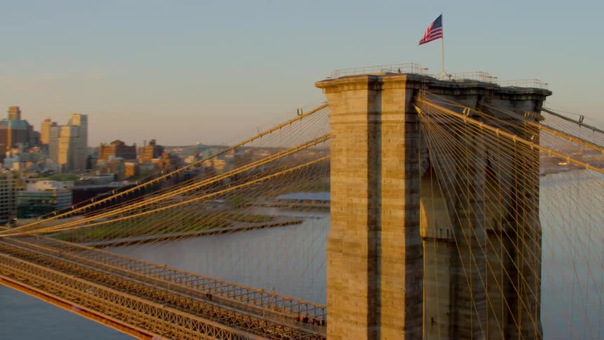 The vehicles travel over the large bridge