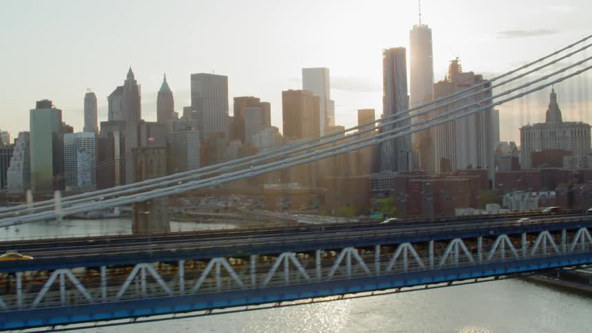 Cars crossing a bridge going in to a downtown area