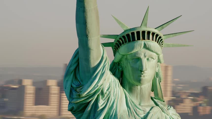 The statue of liberty in front of the city skyline