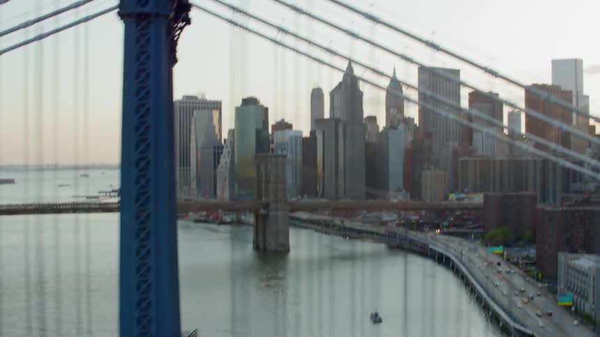 An aerial view of cars driving over the brooklyn bridge