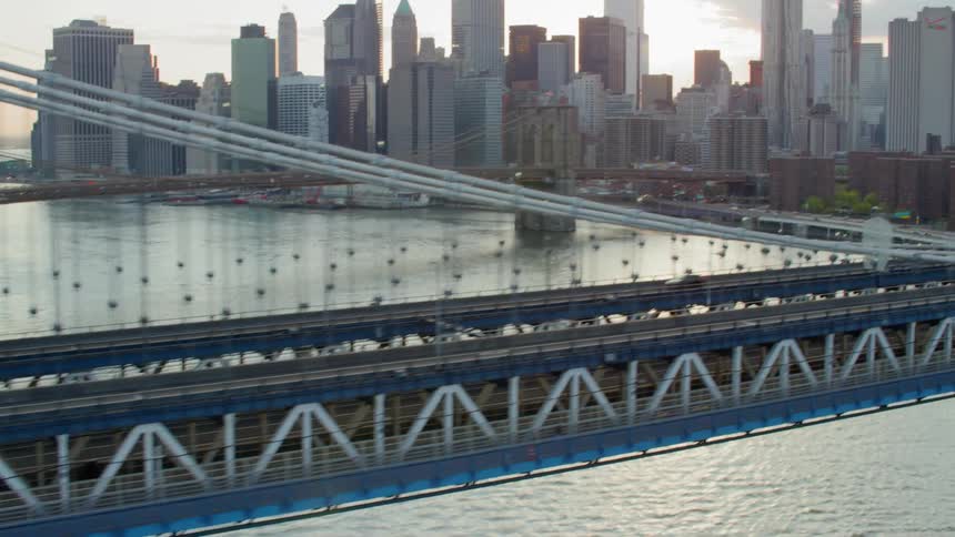 Vehicles drive across a bridge that connects to downtown