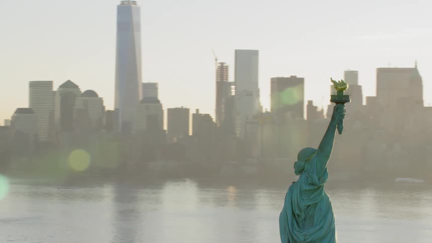 The city beyond the statue of liberty is covered in haze and fog