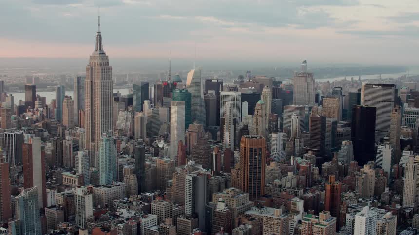 New york city skyscrapers at sunrise under clouds