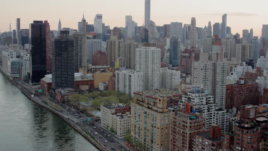 A large urban area sits on the shore of a river