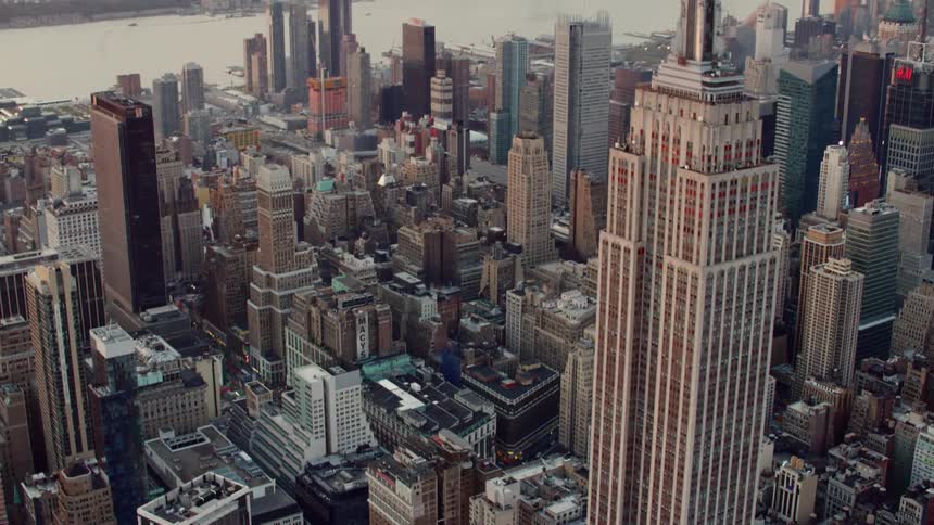 A skyscraper towers over the large downtown area