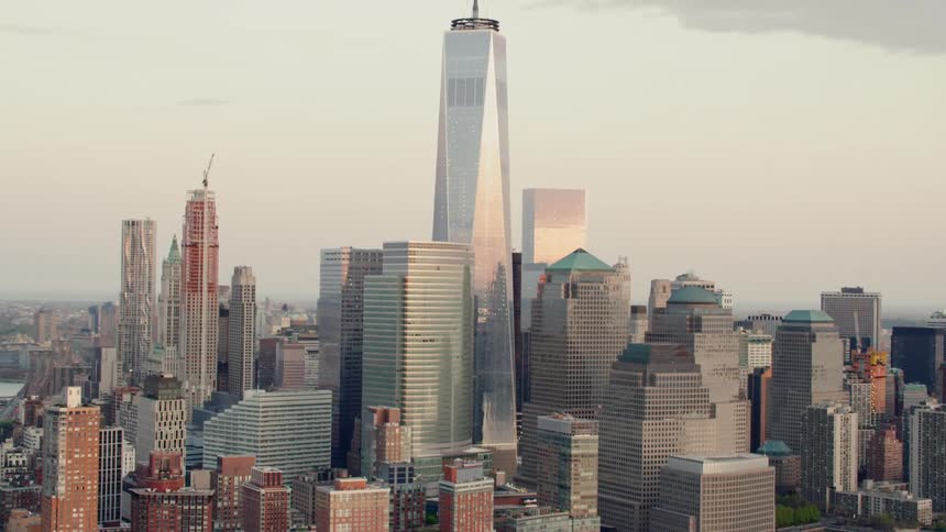 A tall building sits in the center of a row of towers